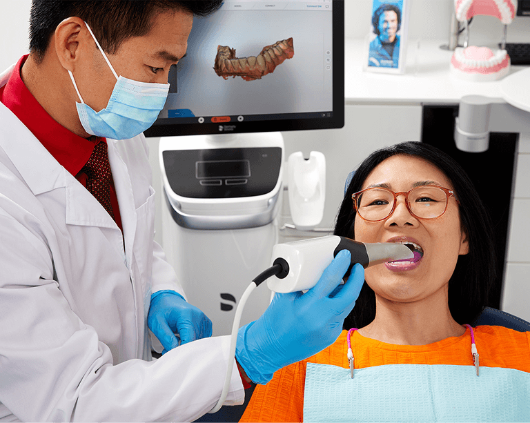 Dental professional demonstrating equipment compatibility with SureSmile software