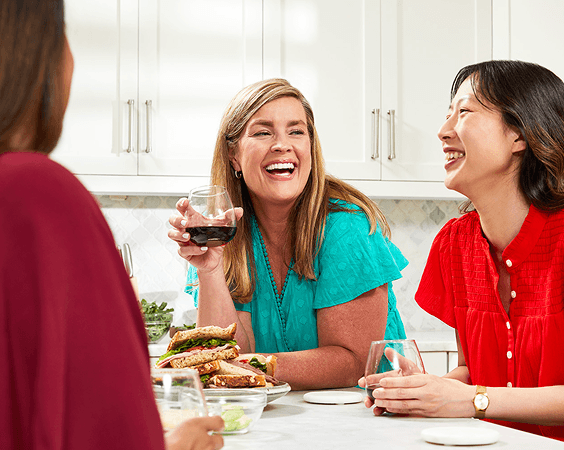 Women laughing together at dinner
