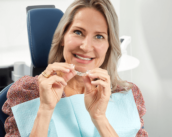 Woman holding clear aligners