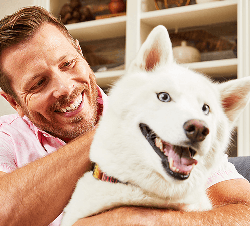 Man with dog smiling